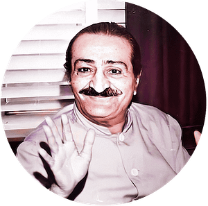 Meher Baba seated on sofa LA